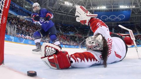 USA's Jocelyne Lamoureux-Davidson (L) scores on Canada's Shannon Szabados during the penalty-shot shootout in the women's gold medal ice hockey match.