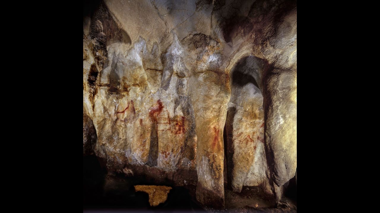 This wall with paintings is in the La Pasiega Cave in Spain. The ladder shape of red horizontal and vertical lines is more than 64,000 years old and was made by Neanderthals.