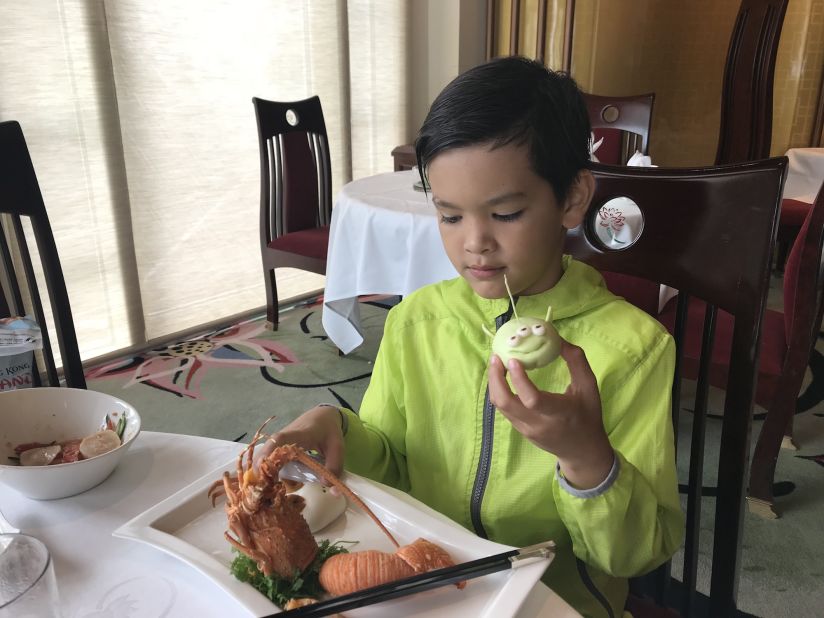 <strong>Crystal Lotus restaurant:</strong> A young Disney fan prepares to enjoy an alien-shaped bun, part of a special dim sum lunch set on offer at the Disneyland Hotel's Crystal Lotus restaurant. 
