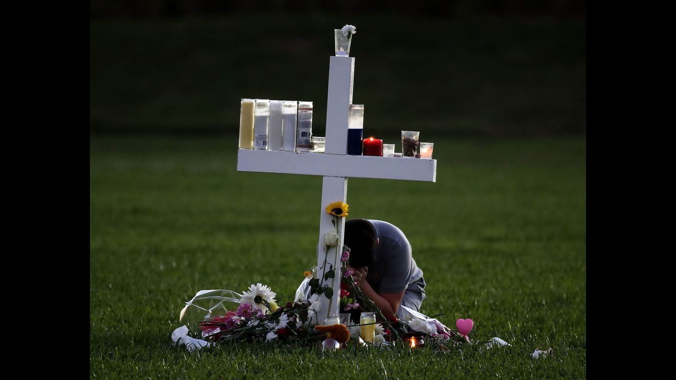 A boy sits on Friday, February 16, at a memorial cross that <a href="https://www.cnn.com/2018/02/15/us/florida-shooting-victims-school/index.html" target="_blank">honors the victims</a> of the mass shooting at Marjory Stoneman Douglas High School in Parkland, Florida. The shooter, 19-year-old former student Nikolas Cruz,<a href="https://www.cnn.com/2018/02/16/us/florida-school-shooting/index.html" target="_blank"> is willing to plead guilty</a>, according to his public defender. 