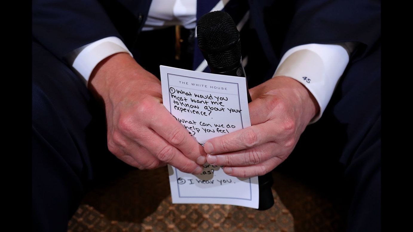 US President Donald Trump holds his notes while hosting a <a href="https://www.cnn.com/2018/02/21/politics/trump-listening-sessions-parkland-students/index.html" target="_blank">listening session with student survivors</a> of mass shootings, their parents and teachers in the State Dining Room at the White House on Wednesday, February 21. The <a href="https://www.cnn.com/2018/02/21/politics/trump-parkland-notecard/index.html" target="_blank">visible points include prompts</a> such as "1. What would you most want me to know about your experience?" "2. What can we do to help you feel safe?" and "5. I hear you."