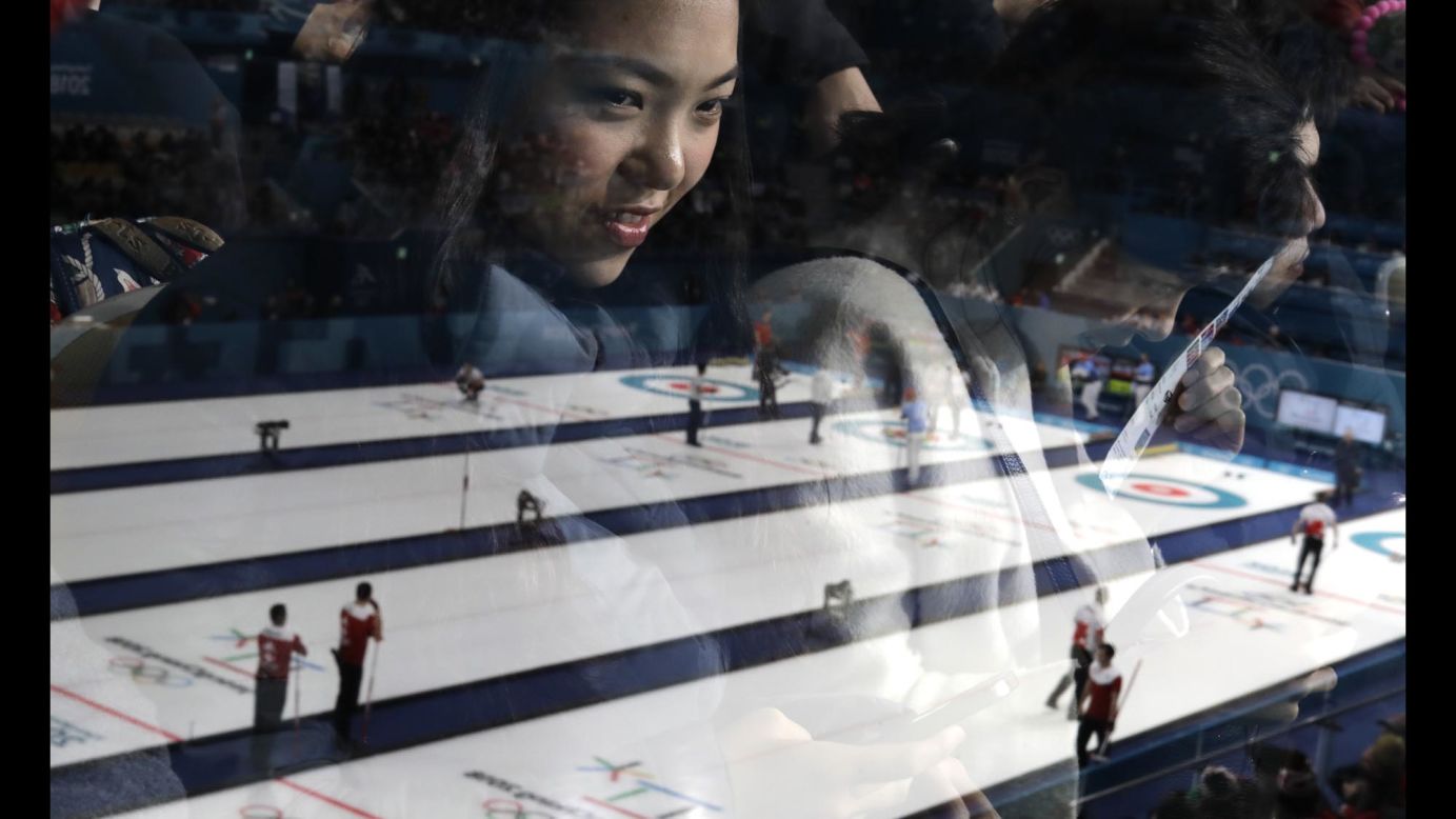 A woman is seen through glass as she watches the men's curling matches at the 2018 Winter Olympics on <a href="http://www.cnn.com/2018/02/18/sport/gallery/winter-olympics-0218/index.html" target="_blank">Sunday, February 18</a>.