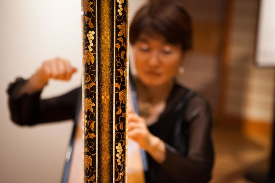 A harp decorated using a lacquerware technique called maki-e, which literally translates as "sprinkled picture."