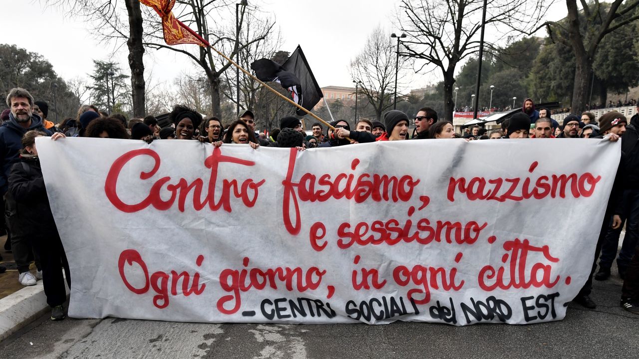 Protesters hold a banner reading "Against fascism, racism and sexism, everyday, in all cities'' during a demonstration in Macerata on February 10. 