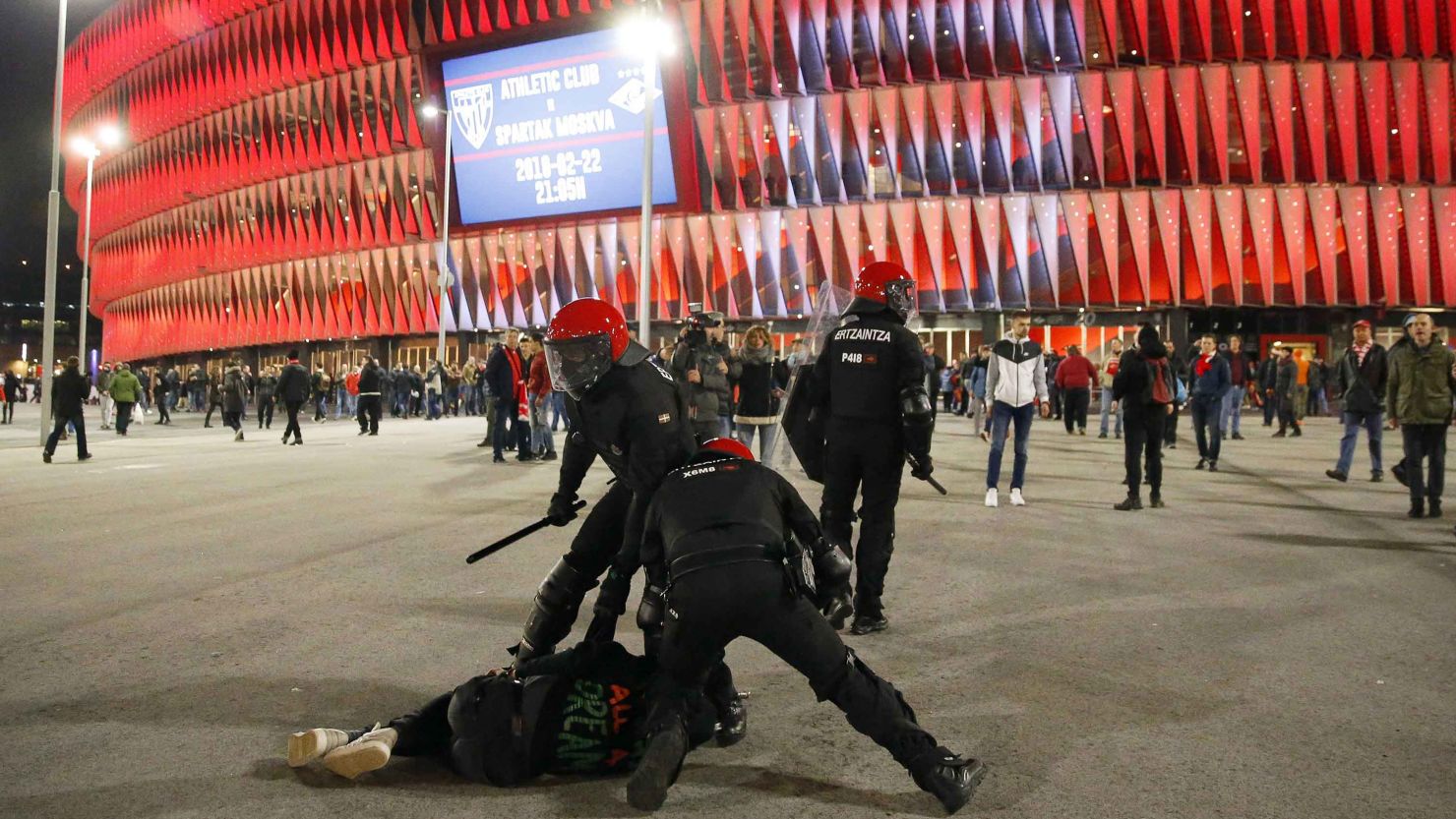 Police officers detain a man during riots prior to the match between Athletic Bilbao and Spartak Moscow.