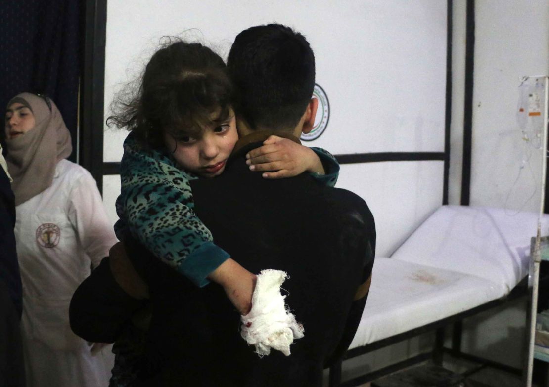 A wounded girl is carried in Douma, Eastern Ghouta.