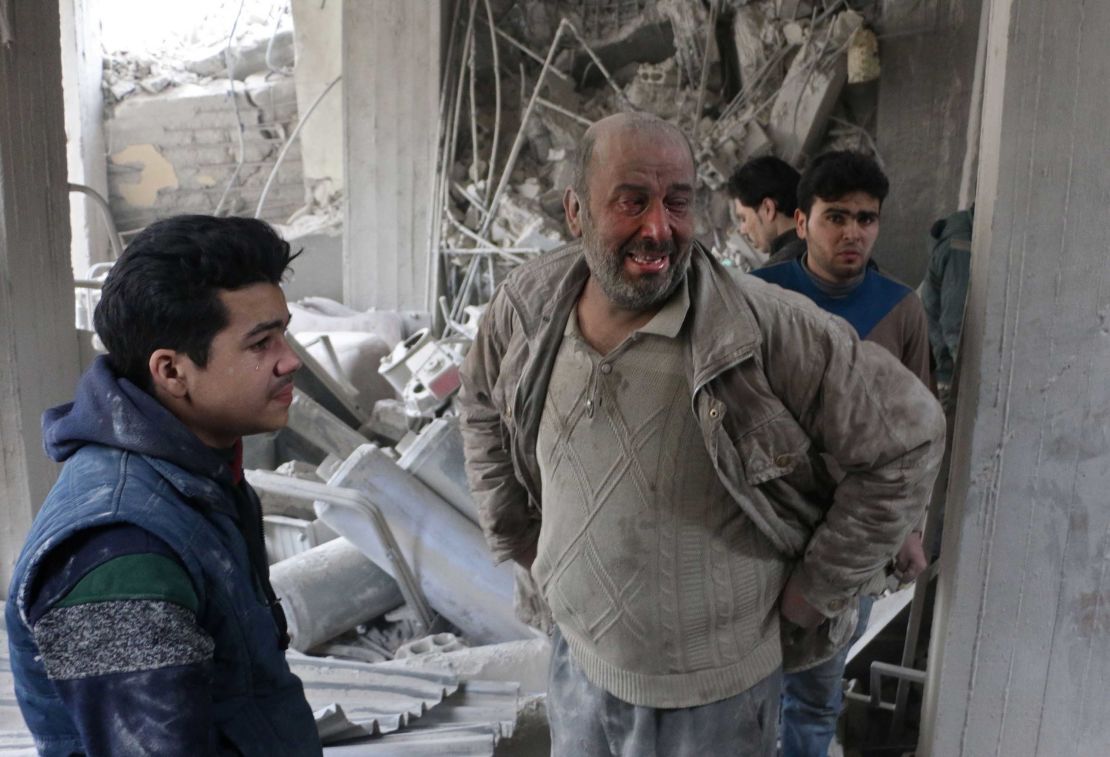 Syrians look for survivors at the site of strikes in Douma, in  Eastern Ghouta, on Thursday.