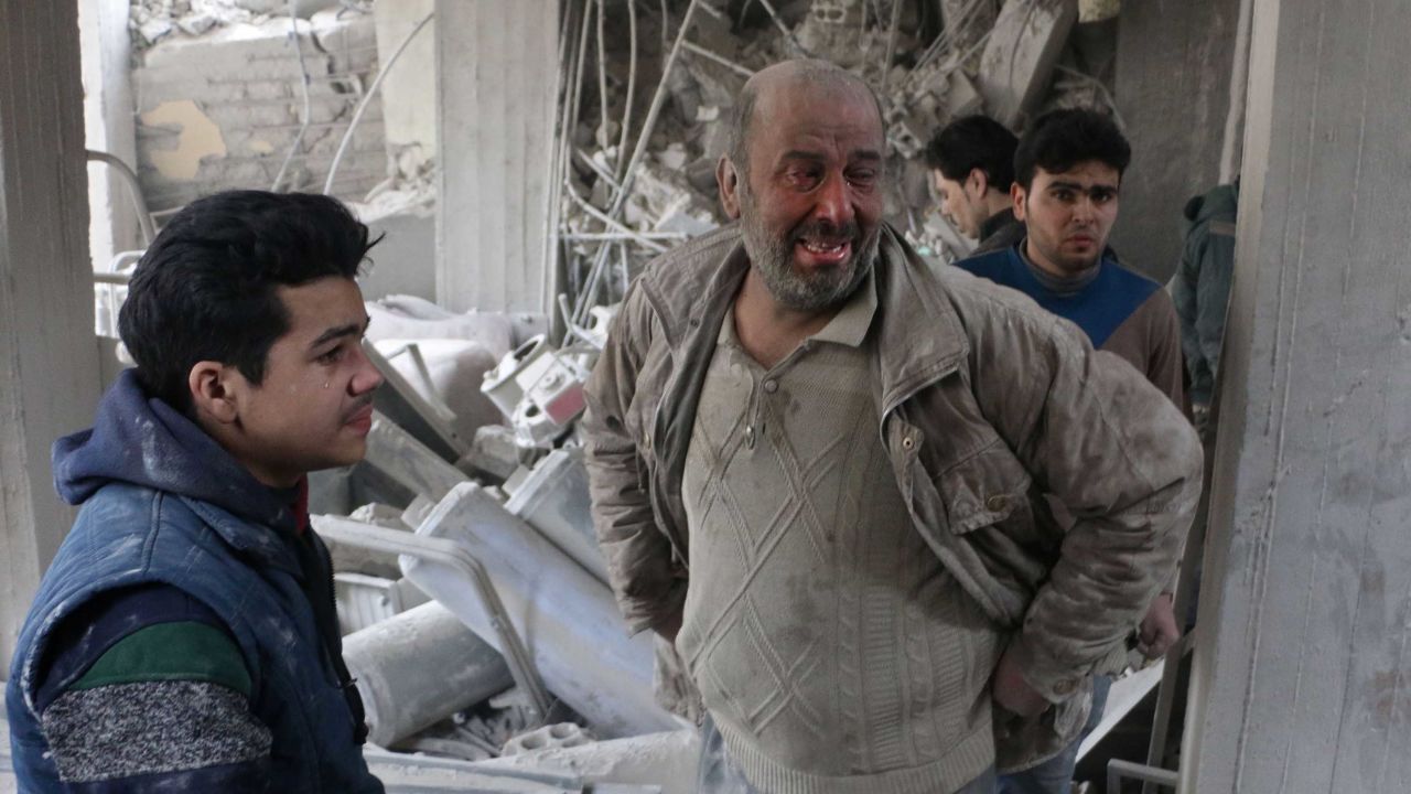 Syrians look for survivors at the site of strikes in Douma, in  Eastern Ghouta, on Thursday.