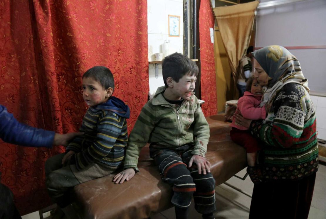 Inujured Syrian children cry as they wait to receive medical treatment at a field hospital after strikes on Kafr Batna in Eastern Ghouta on Thursday.