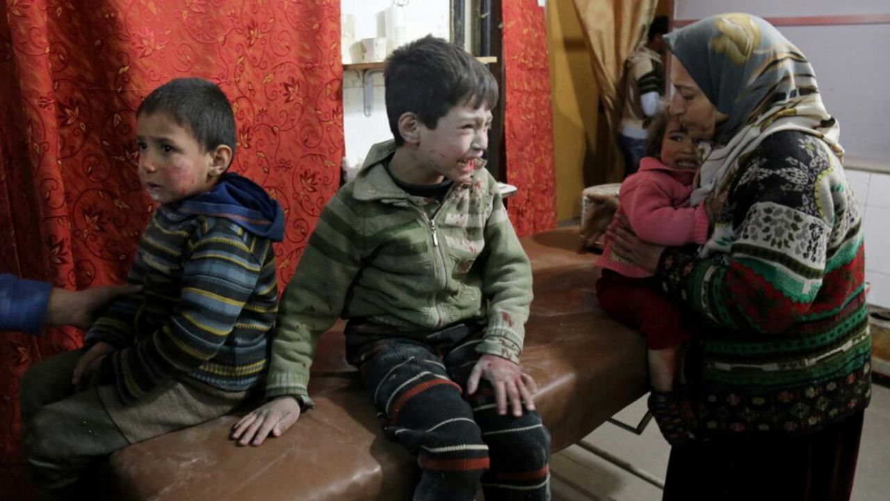 Inujured Syrian children cry as they wait to receive medical treatment at a field hospital after strikes on Kafr Batna in Eastern Ghouta on Thursday.
