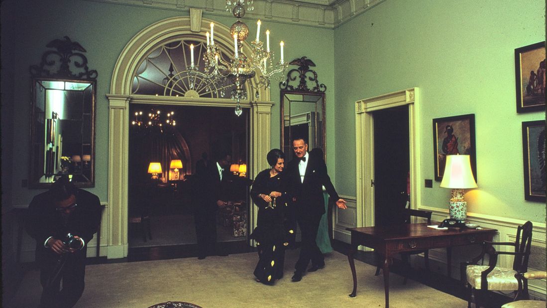 In this photograph President Lyndon B. Johnson walks Indian prime minister Indira Gandhi into the Center Hall prior to a State Dinner held in her honor on March 28, 1966. The Center Hall is located on the Second Floor of the White House, in the family quarters.