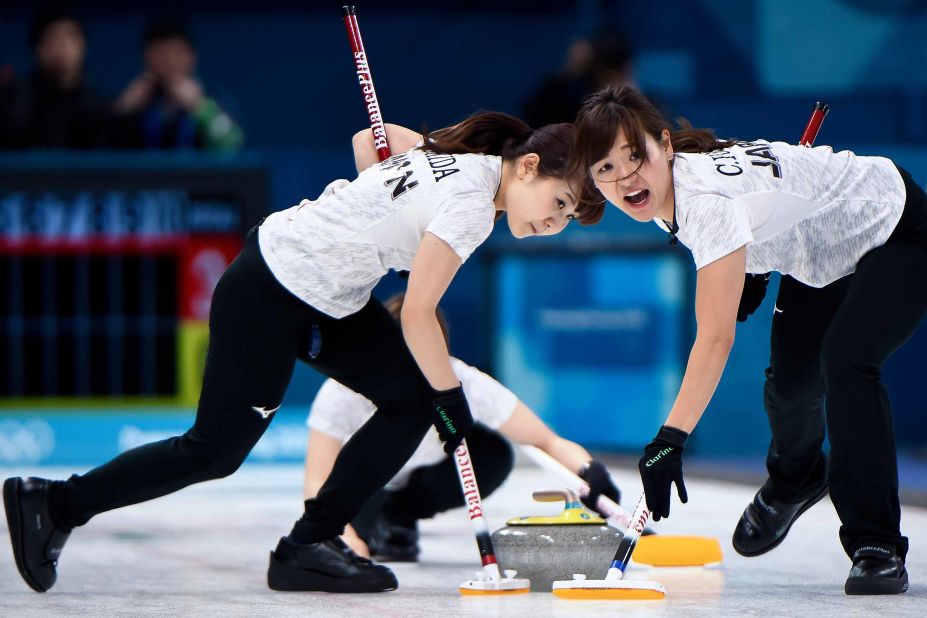 Japan's Yurika Yoshida, left, and Chinami Yoshida brush the ice during the match against South Korea.