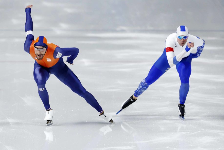 Dutch speedskater Kjeld Nuis, left, races next to Finland's Mika Poutala in the 1,000 meters. Nuis won the gold, his second of the Games.