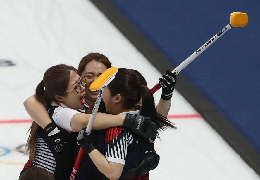 The South Korean women's curling team celebrate after defeating Japan to advance to the final.