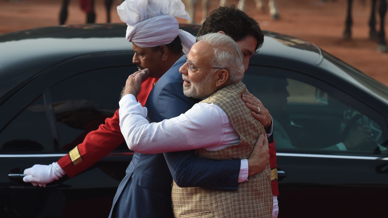 India's Prime Minister Narendra Modi (R) embraces Canada's Prime Minister Justin Trudeau (C) during a ceremonial reception at the Presidential Palace in New Delhi on February 23, 2018.
