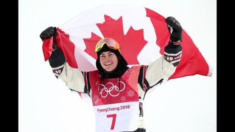 Sebastien Toutant celebrates with the Canadian flag after winning the big-air snowboarding event. The event was making its Olympic debut.