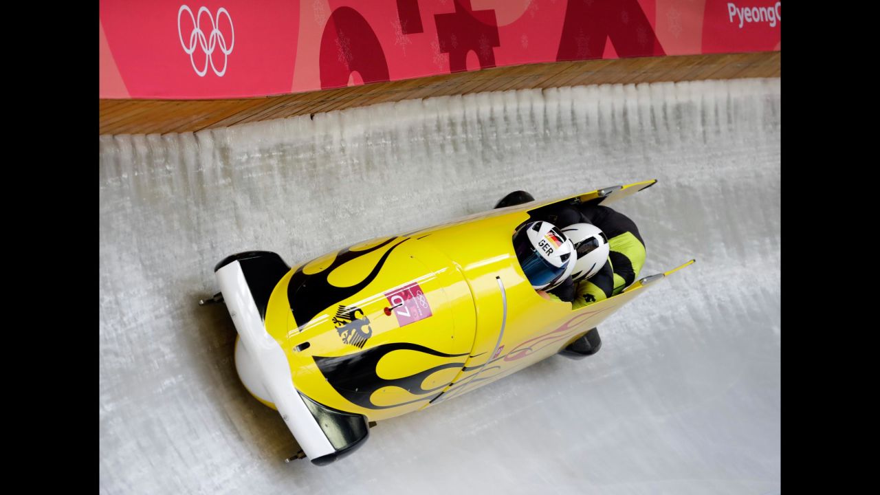 Francesco Friedrich pilots a four-man bobsled for Germany. Friedrich's team leads halfway through the competition.