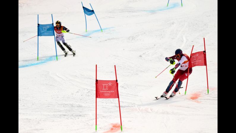 Switzerland's Ramon Zenhaeusern, right, leads Germany's Alexander Schmid as they race during the team skiing event. The Swiss team would go on to win the gold.