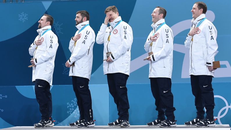 US curler Matt Hamilton, center, cries during the medal ceremony.