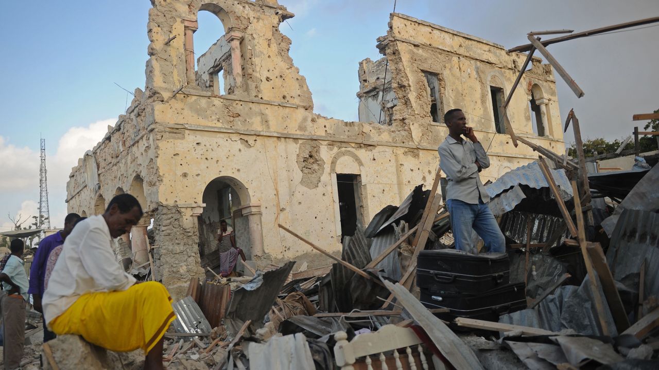 Residents survey remains after the Friday bombings in Mogadishu.
