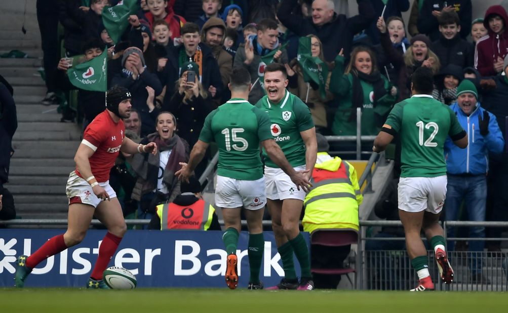 Jacob Stockdale celebrates with teammates after scoring an early try against  Wales in Dublin.