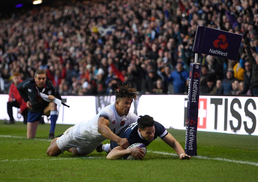 Sean Maitland goes over for Scotland's second try under pressure from Anthony Watson of England. 