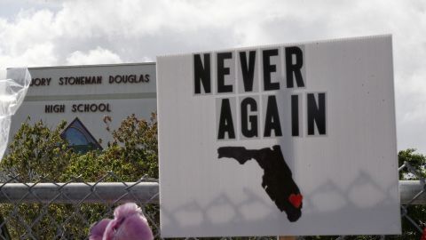 Memorials are seen on a fence surrounding Marjory Stoneman Douglas High School in Parkland, Florida on February 21, 2018. 