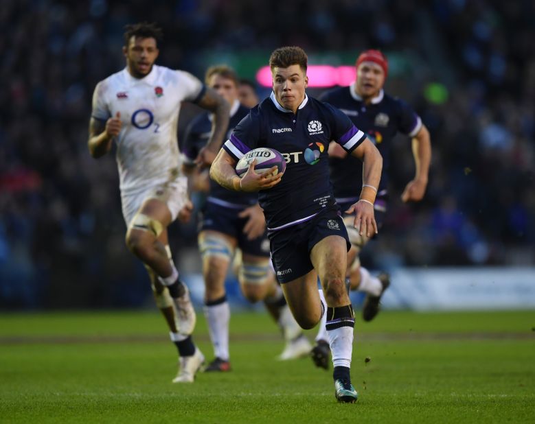 Huw Jones breaks clear again to score his second try and Scotland's third of the opening half against England.