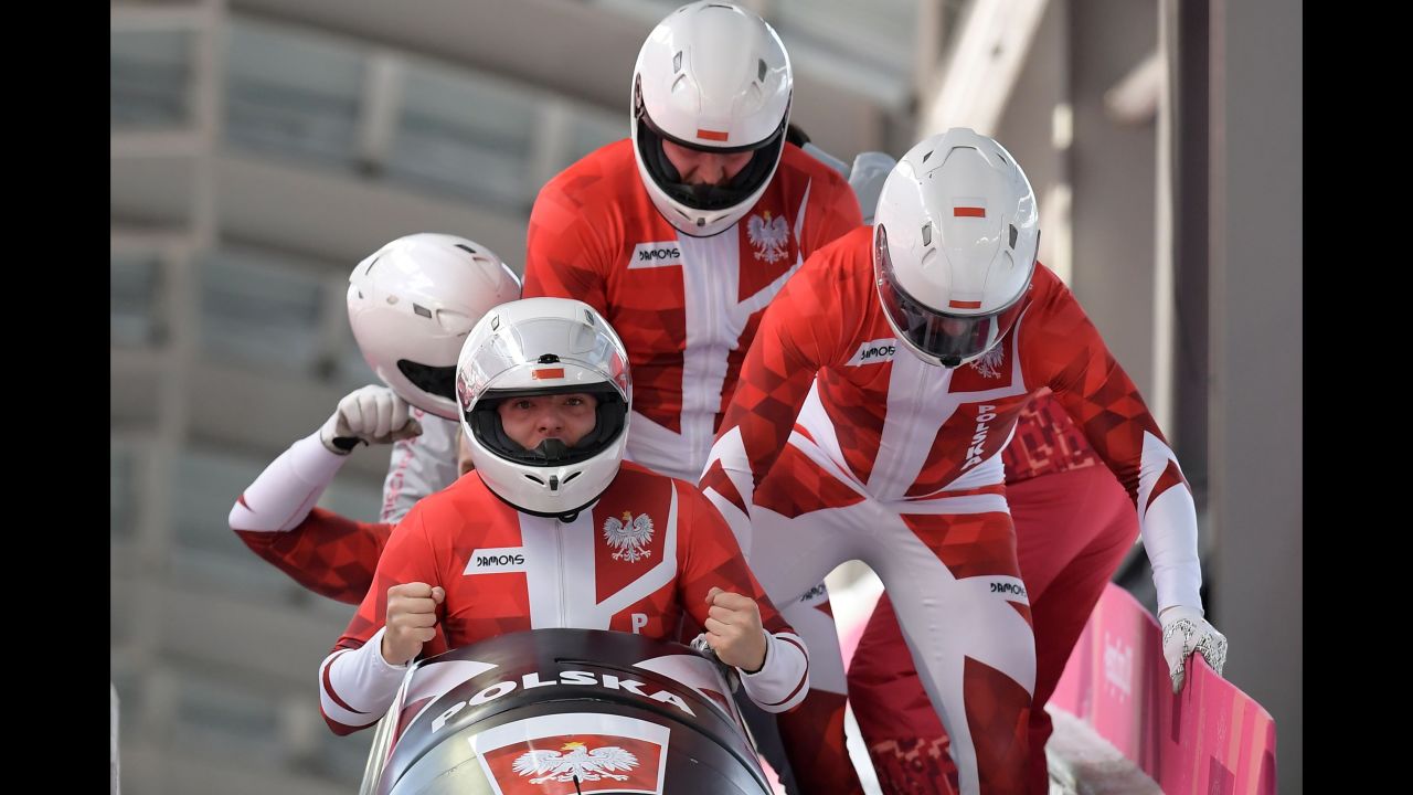 A Polish bobsled team piloted by Mateusz Luty reacts after its final run.