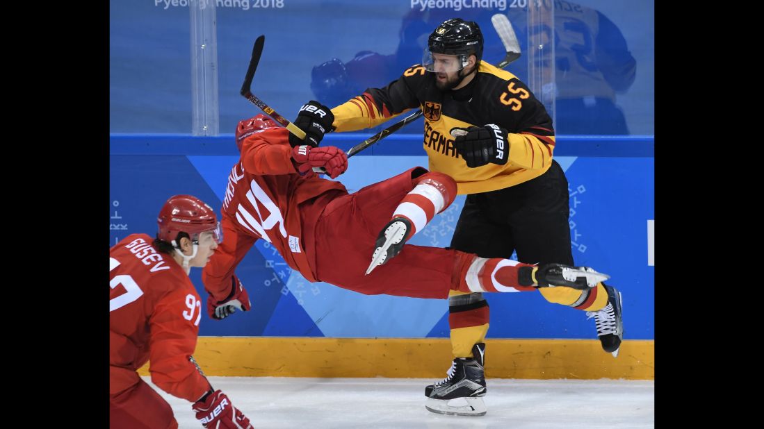 Germany's Felix Schutz, right, checks Russian Yegor Yakovlev in the gold-medal hockey game.