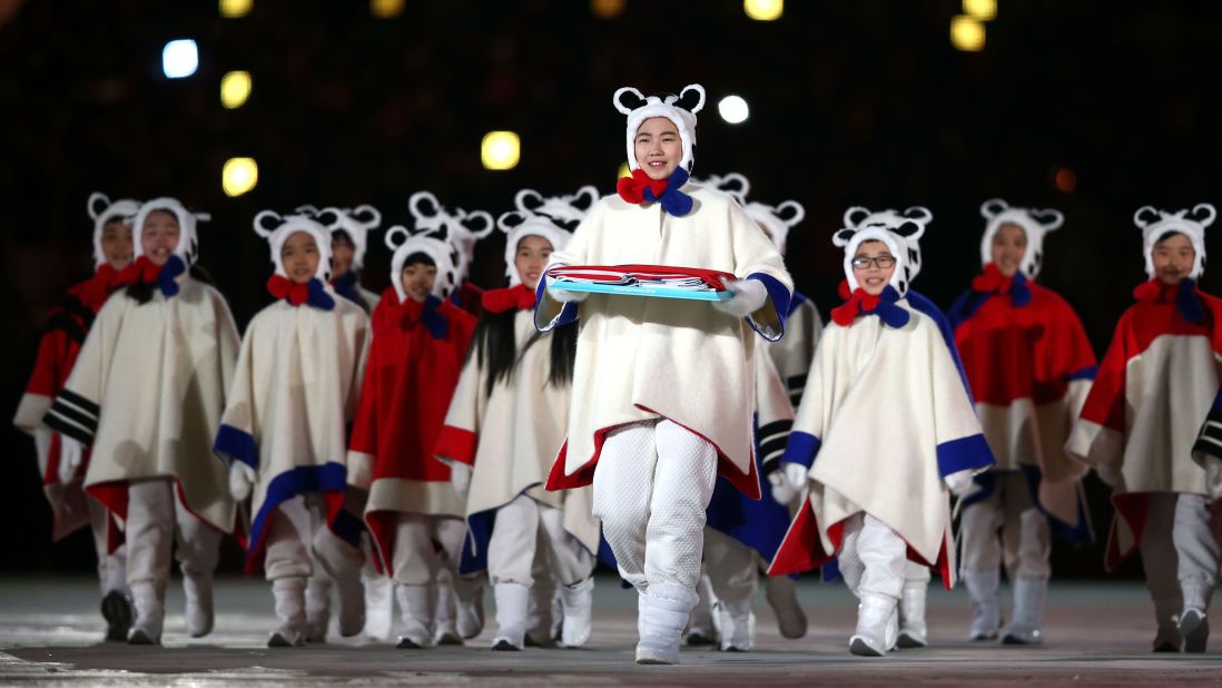 Performers carry the South Korean flag during the closing ceremony.