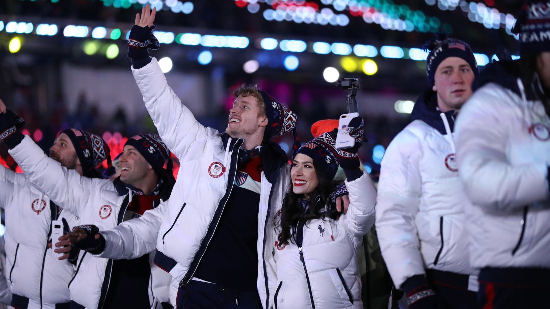 Figure skaters Madison Chock and Evan Bates walk with Team USA during the closing ceremony.