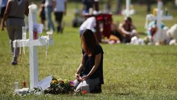 PARKLAND, FL - FEBRUARY 17: A young girl sits at a temporary memorial at Pine Trails Park on February 17, 2018 in Parkland, Florida. Police have arrested former student Nikolas Cruz and charged him with 17 murders for the shooting at Marjory Stoneman Douglas High School on February 14.  (Photo by Mark Wilson/Getty Images)