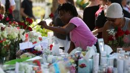 PARKLAND, FL - FEBRUARY 17: People bring flowers to a temporary memorial at Pine Trails Park on February 17, 2018 in Parkland, Florida. Police have arrested former student Nikolas Cruz and charged him with 17 murders for the shooting at Marjory Stoneman Douglas High School on February 14.  (Photo by Mark Wilson/Getty Images)