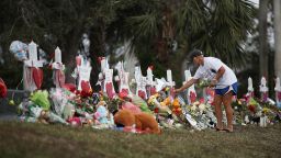 PARKLAND, FL - FEBRUARY 20:  Melissa Shev visits a makeshift memorial setup in front of Marjory Stoneman Douglas High School in memory of the 17 people that were killed on February 14, on February 20, 2018 in Parkland, Florida. Police arrested 19-year-old former student Nikolas Cruz for killing 17 people at the high school.  (Photo by Joe Raedle/Getty Images)
