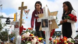 PARKLAND, FL - FEBRUARY 20:  Marissa Rodriguez (L) and Ambar Ramirez visit a makeshift memorial setup in front of Marjory Stoneman Douglas High School in memory of the 17 people that were killed on February 14, on February 20, 2018 in Parkland, Florida. Police arrested 19-year-old former student Nikolas Cruz for killing 17 people at the high school.  (Photo by Joe Raedle/Getty Images)