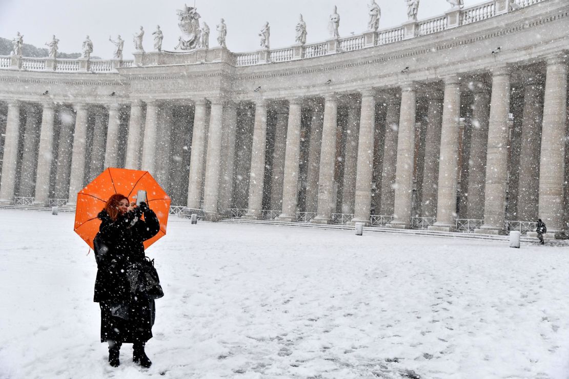 A woman braves freezing conditions at St. Peter's Square.  