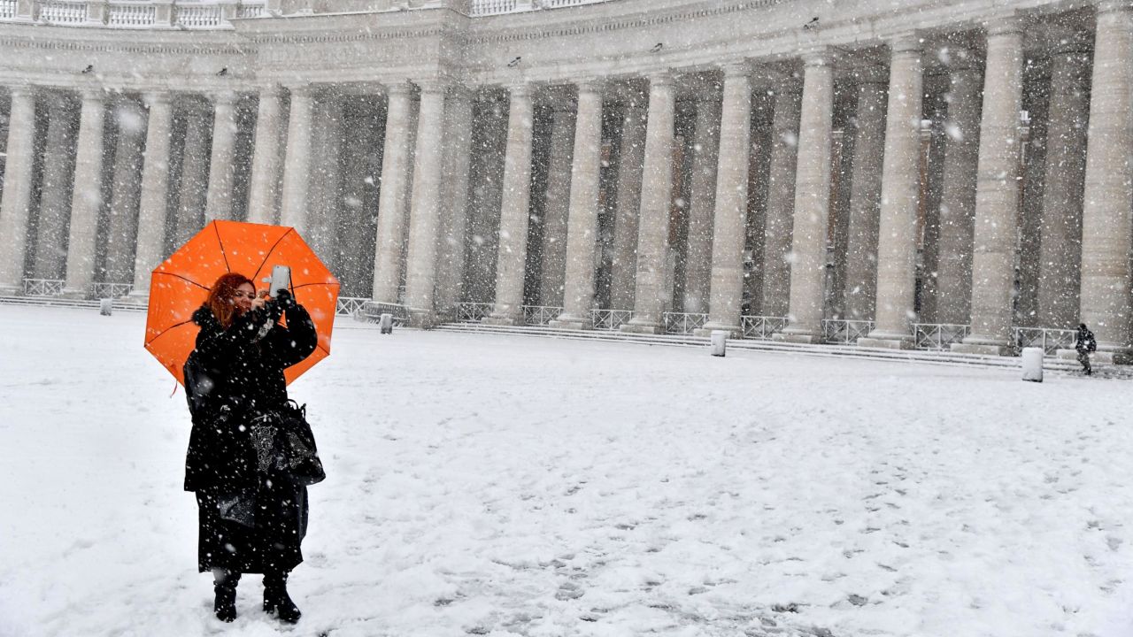 A woman braves freezing conditions at St. Peter's Square.  