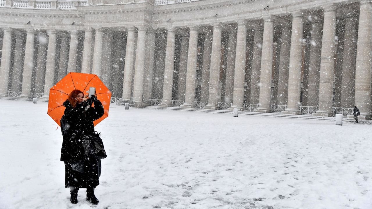 A woman braves freezing conditions at St. Peter's Square.