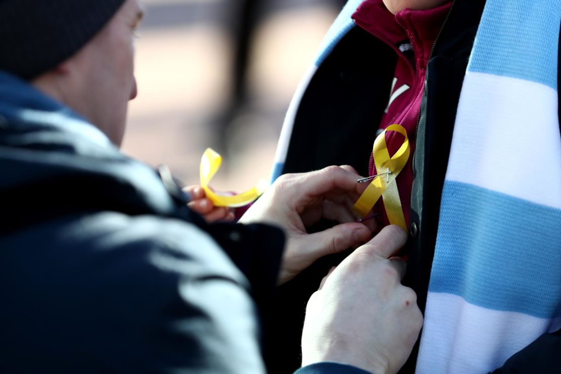 Fans wear a yellow ribbon in support of Pep Guardiola during the Carabao Cup Final between Arsenal and Manchester City at Wembley Stadium.