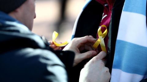 Fans wear a yellow ribbon in support of Pep Guardiola during the Carabao Cup Final between Arsenal and Manchester City at Wembley Stadium.