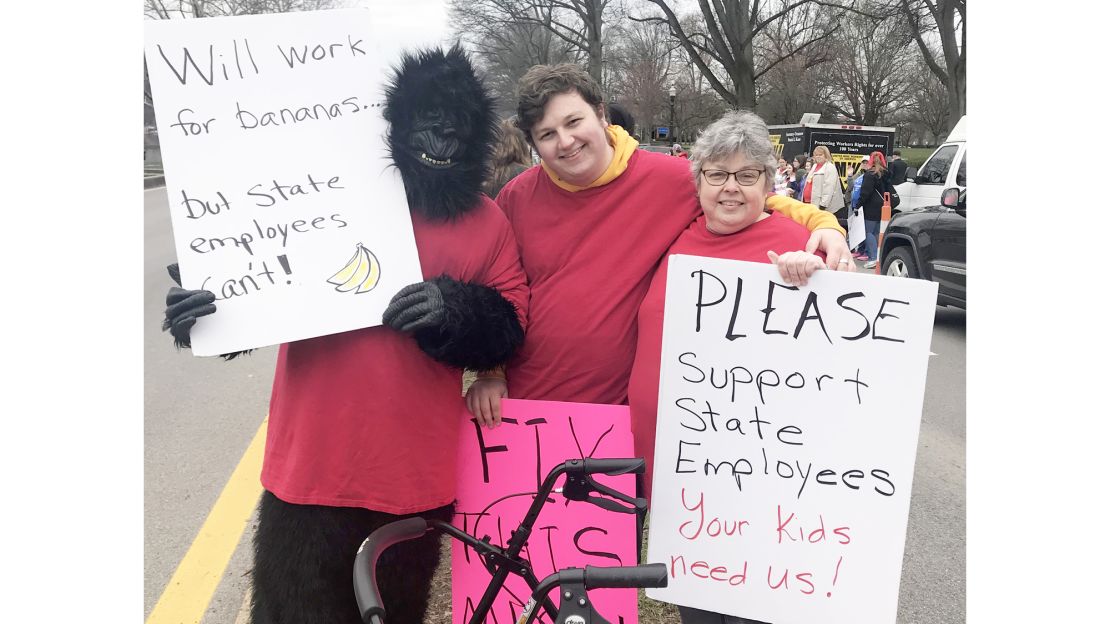 Ninth-grade teacher Melissa Whitener (right) pickets with her two sons Monday.