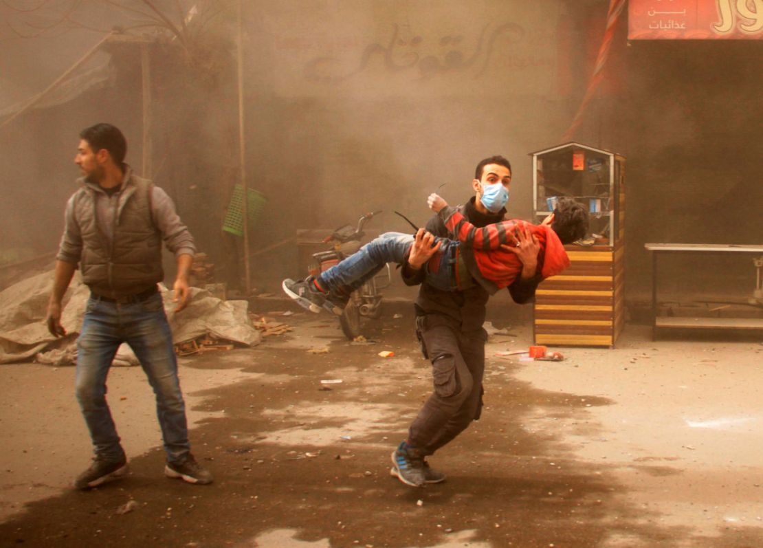  A member of the Syrian Civil Defence carries an injured child following air strikes on Eastern Ghouta on February 7.