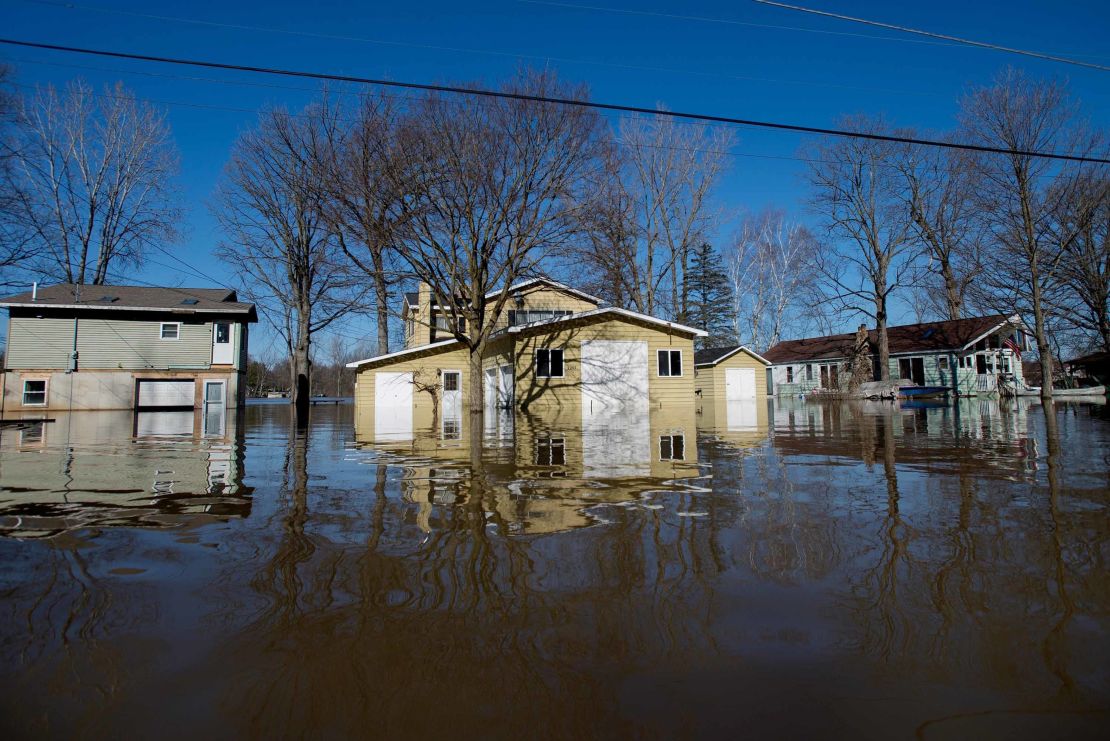 Flooding along Riverbank Avenue on Monday in Plainfield Township, Michigan.