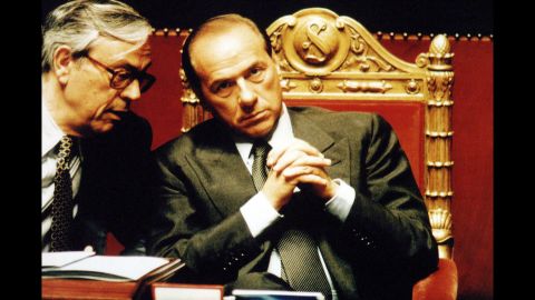 Berlusconi chats with lawmaker Cesare Previti at the Italian Senate during a vote of confidence for Berlusconi's government on May 17, 1994.