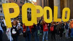 Five star Movement (M5S) supporters hold up letters of the alphabet that read "People" during a protest near the Pantheon against the government's decision to vote a bill for a new electoral law (known as "Rosatellum") to a confidence vote in Rome on October 25, 2017. A controversial bill for a new election law passed the first of five confidence votes today in the Senate.  / AFP PHOTO / Alberto PIZZOLI        (Photo credit should read ALBERTO PIZZOLI/AFP/Getty Images)