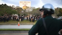 PARKLAND, FL - FEBRUARY 28: Police officers stand in front of Marjory Stoneman Douglas High School as student arrive to attend classes for the first time since the shooting that killed 17 people on February 14  at the school on February 28, 2018 in Parkland, Florida.  Police arrested 19-year-old former student Nikolas Cruz for the 17 murders.  (Photo by Joe Raedle/Getty Images)