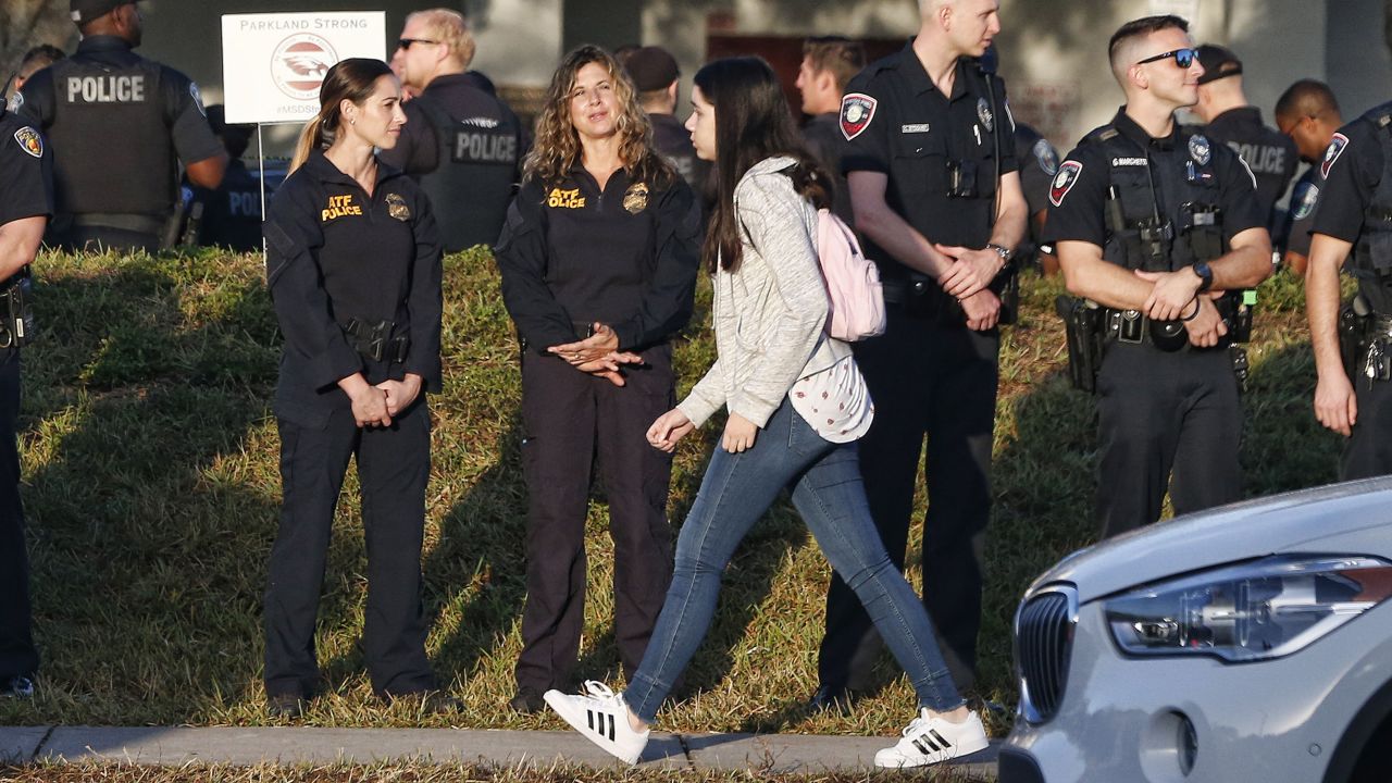 Marjory Stoneman Douglas High School staff, teachers and students return to school on February 28, greeted by police and well wishers in Parkland, Florida.