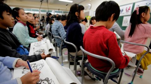 Elementary school students look at mascot choices for the Tokyo 2020 Olympics in Chofu, Tokyo.