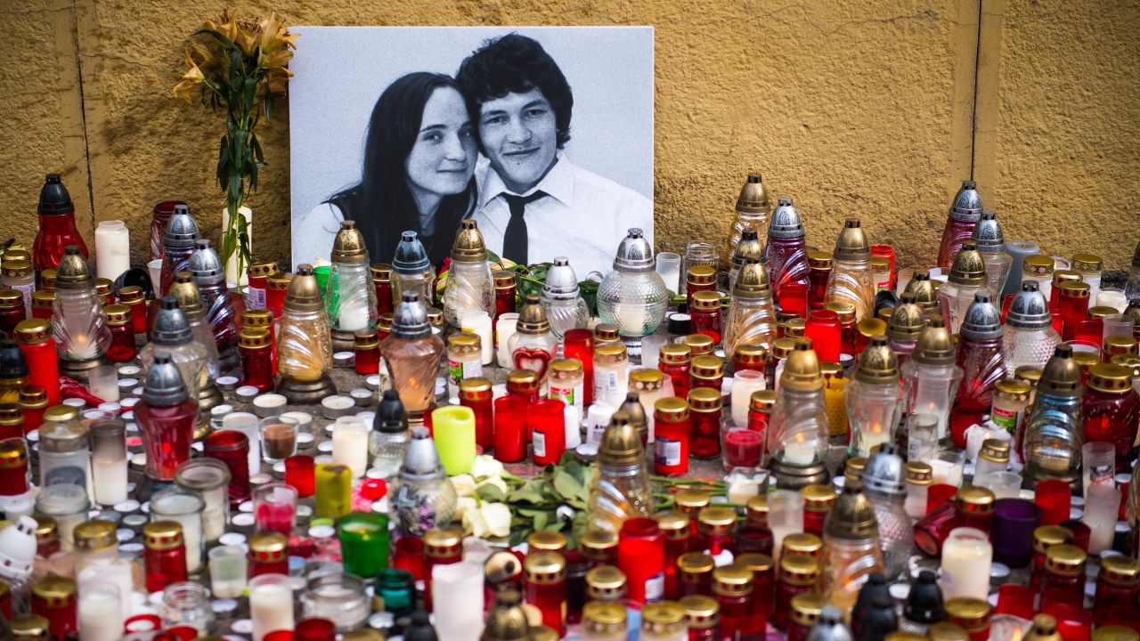 Candles placed in front of a portrait of Slovak investigative journalist Jan Kuciak and his girlfriend Martina Kusnirova.